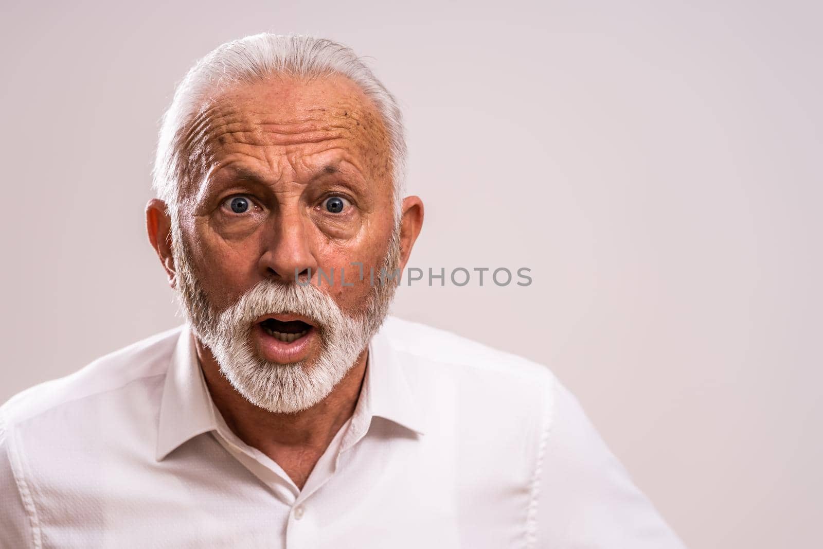 Portrait of surprised and shocked senior man.