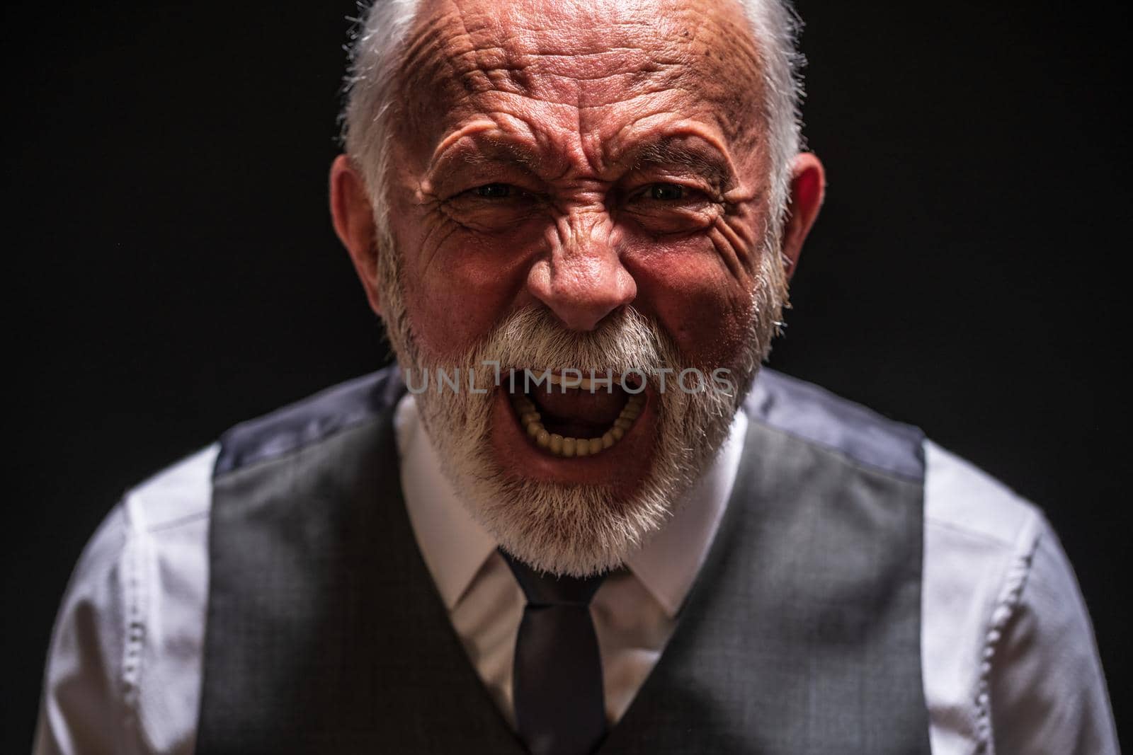 Portrait of furious senior man who is screaming.