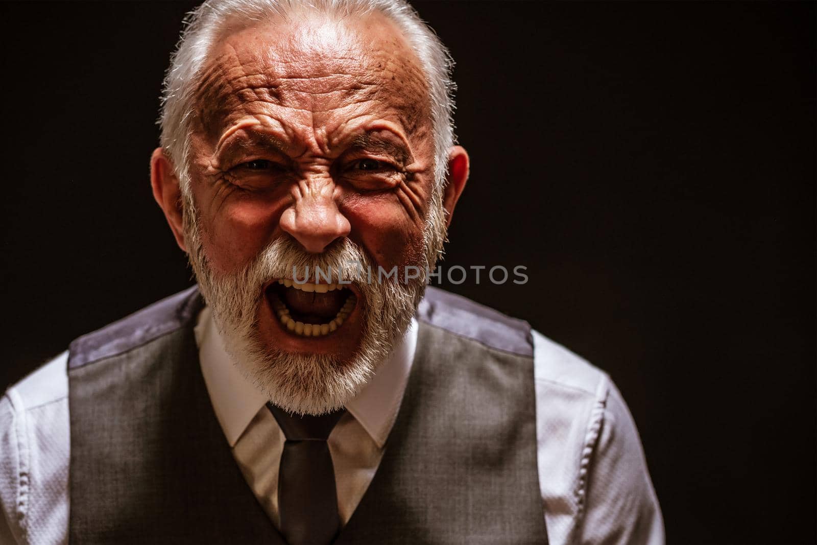 Portrait of furious senior man who is screaming.
