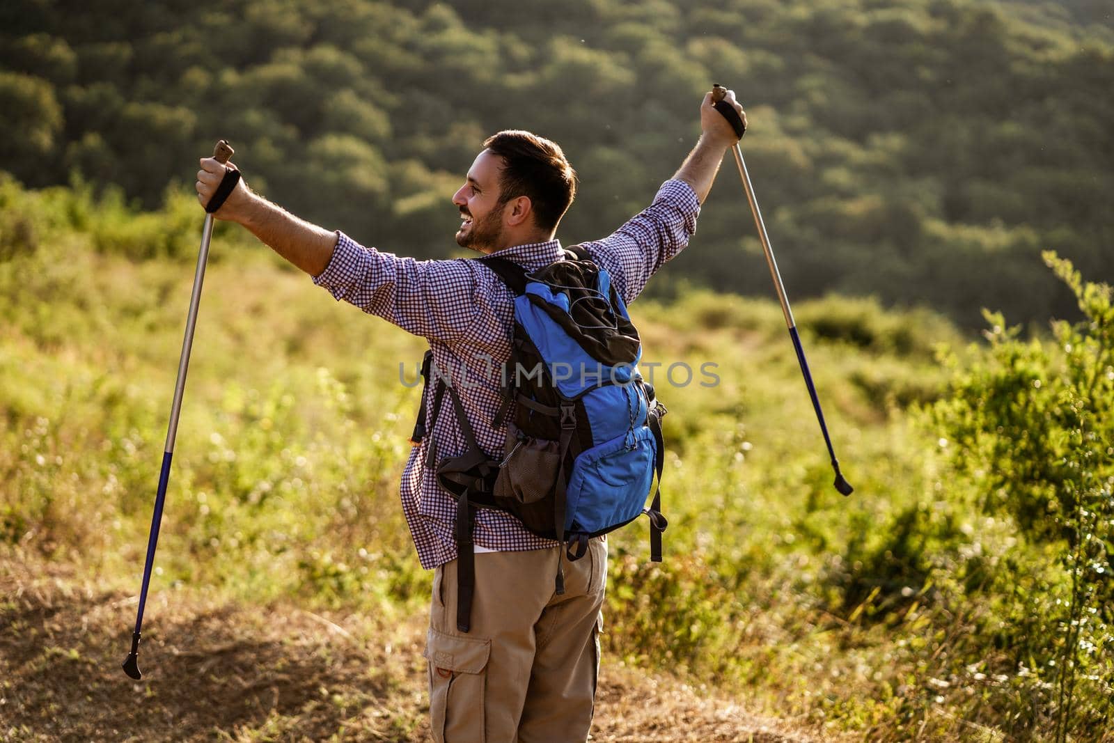 Happy man is ready for hiking in mountain.