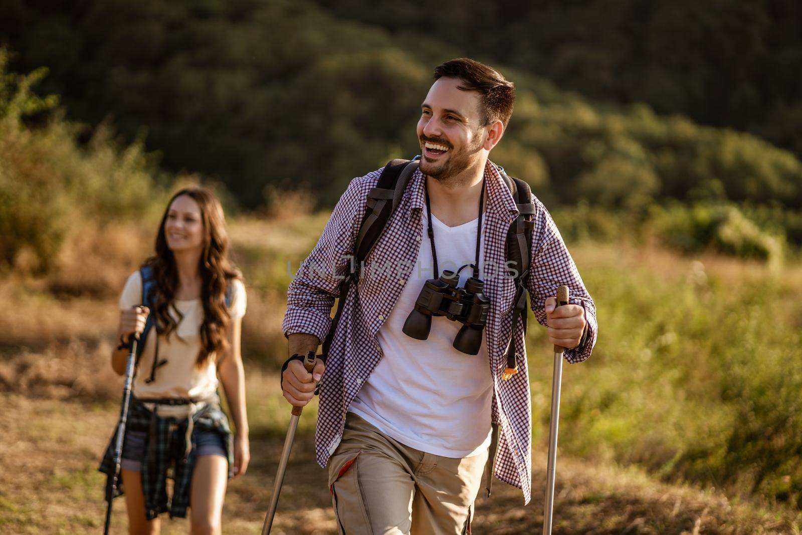 Happy couple is hiking in mountain.