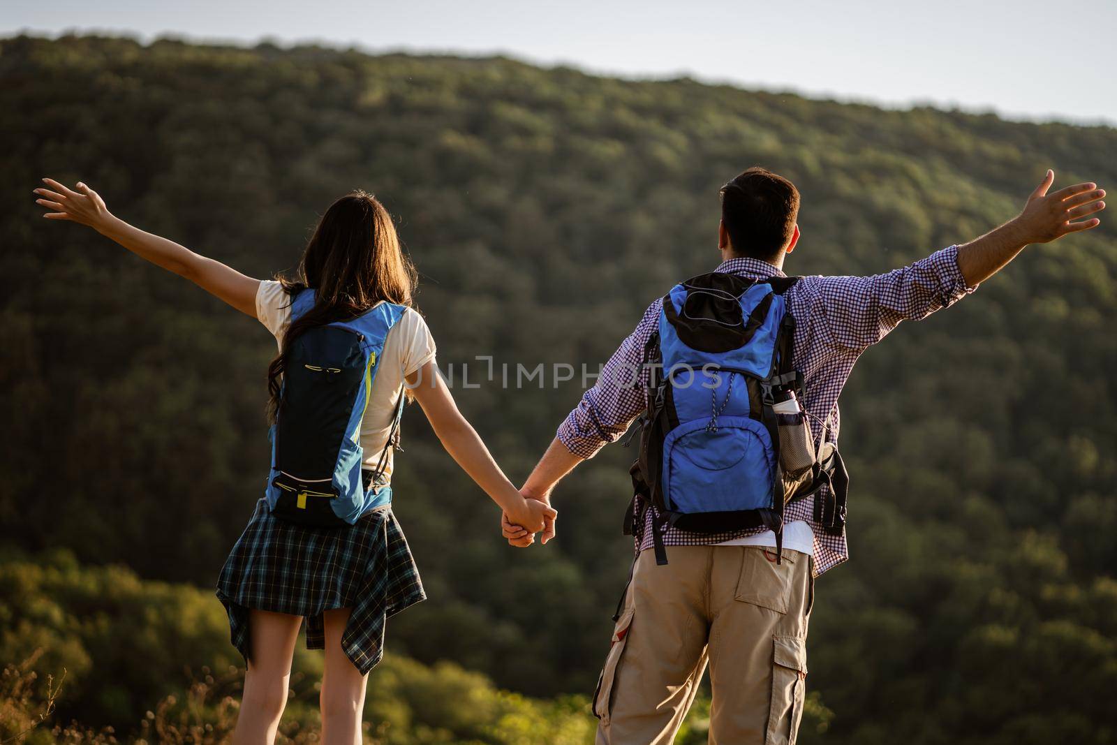 Happy couple is ready for hiking in mountain.