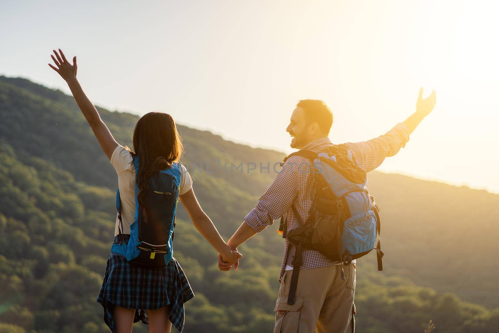 Happy couple is ready for hiking in mountain.