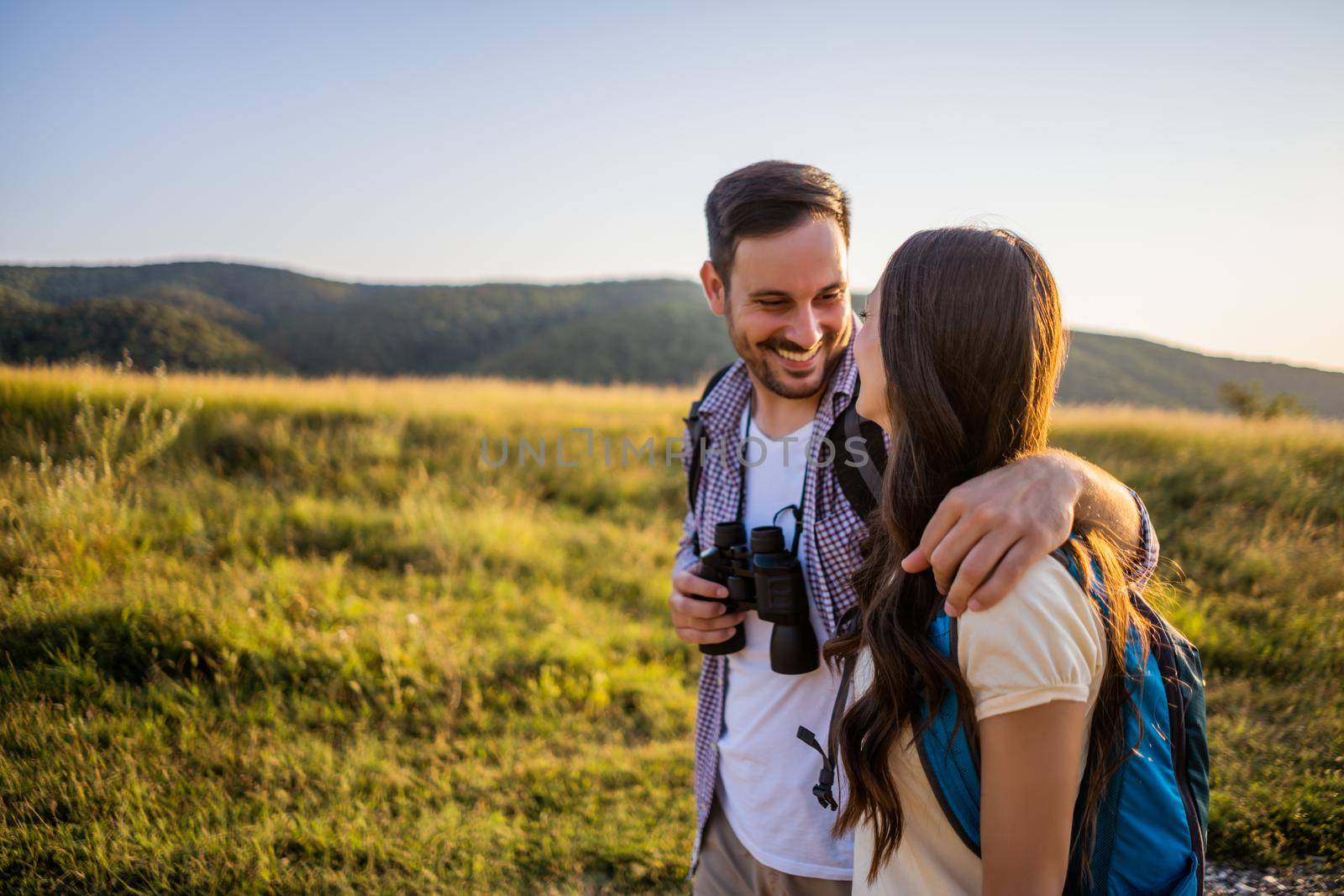 Happy couple is hiking in mountain.