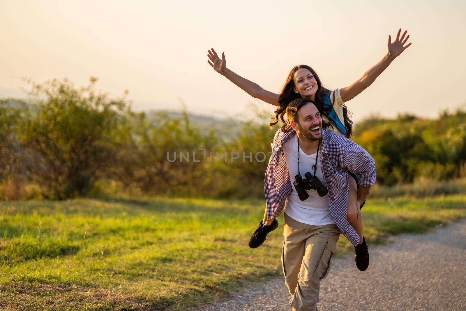 Happy couple is hiking in mountain. They are having fun in nature.