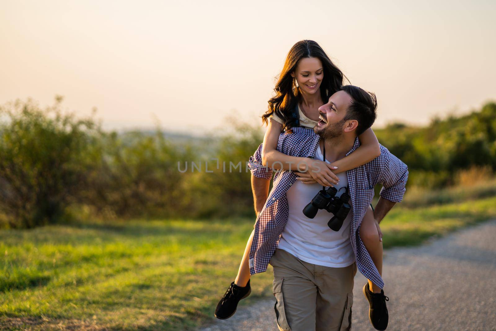 Happy couple is hiking in mountain. They are having fun in nature.