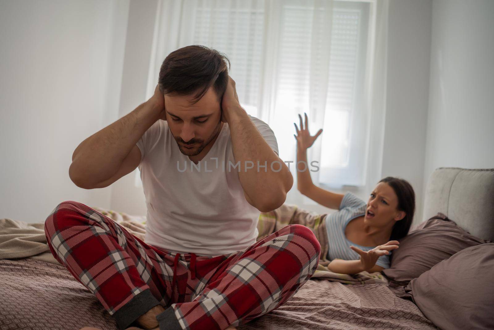 Woman is angry because her man is waking her up.