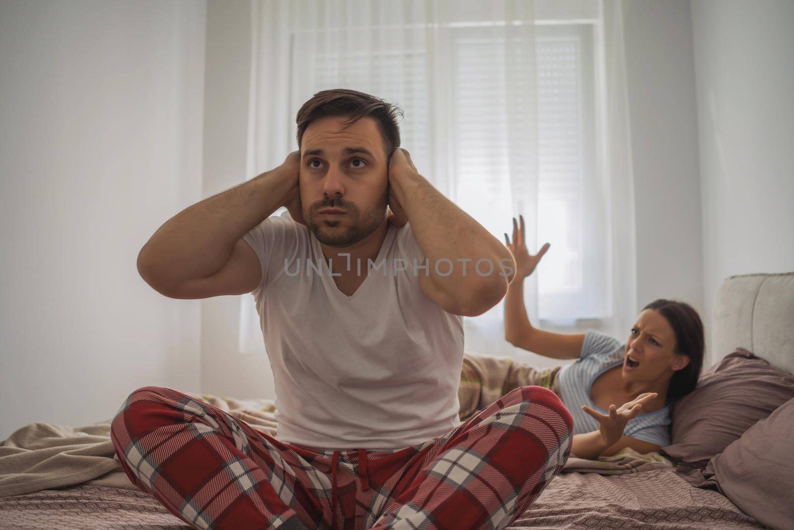 Woman is angry because her man is waking her up.