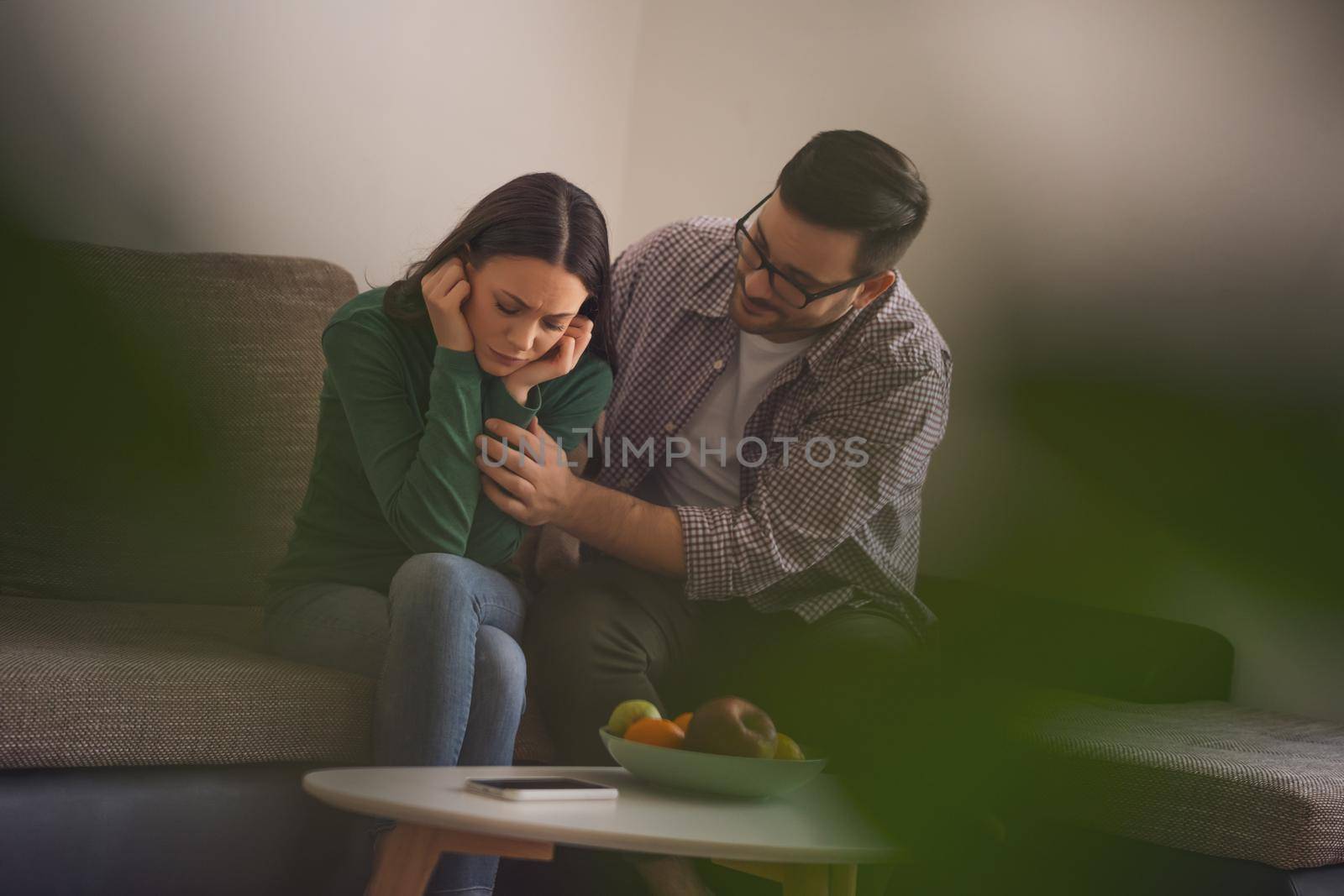 Woman is sad and depressed, her man is consoling her.
