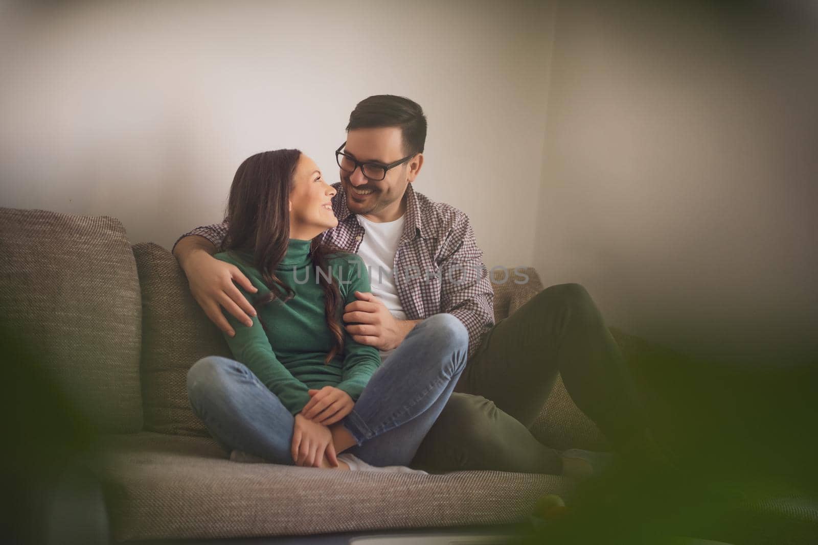 Happy couple in love is relaxing at home.