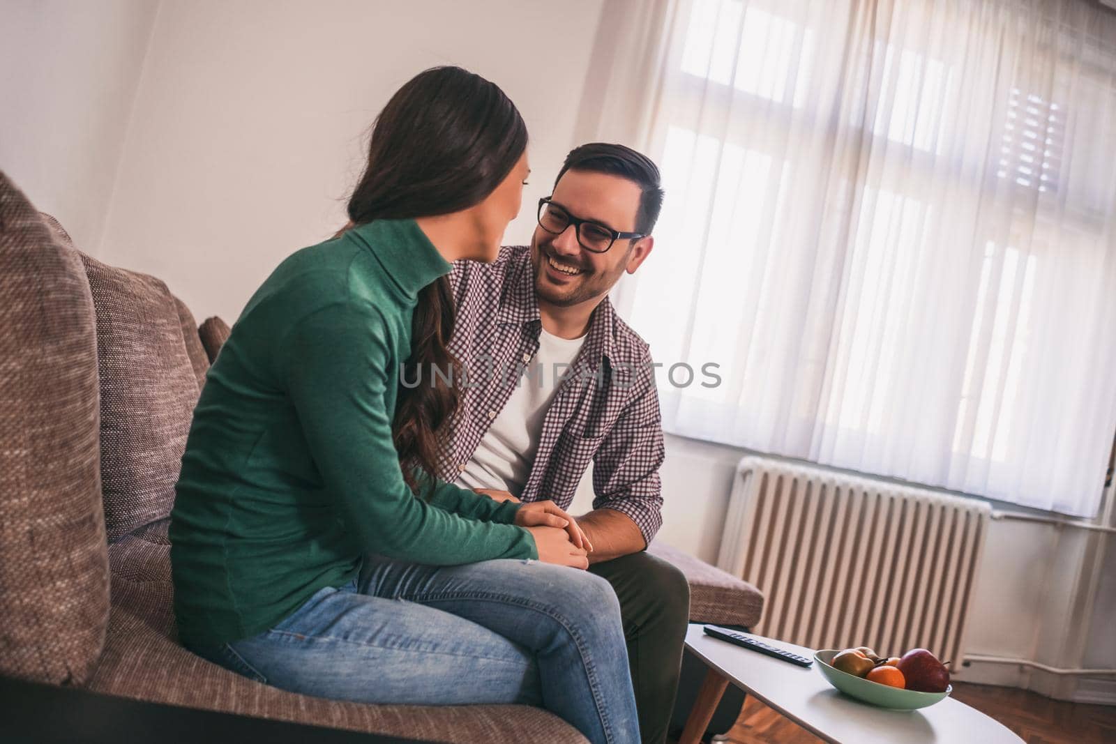 Happy couple is relaxing at home.