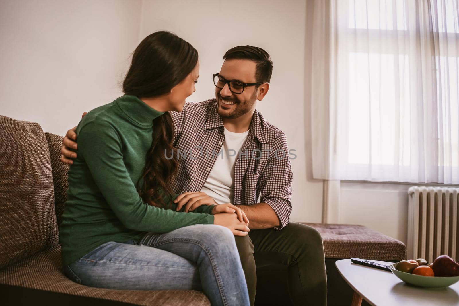 Happy couple is relaxing at home.