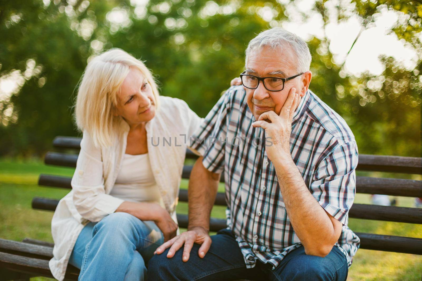 Senior man is sad and depressed. Friend is consoling him.