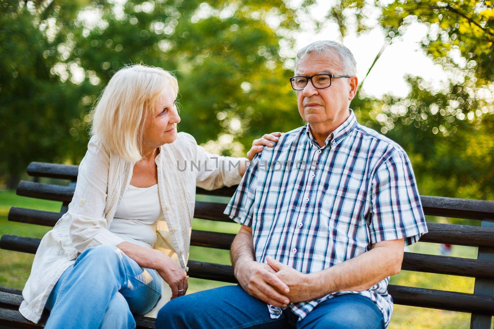 Senior man is sad and depressed. Friend is consoling him.