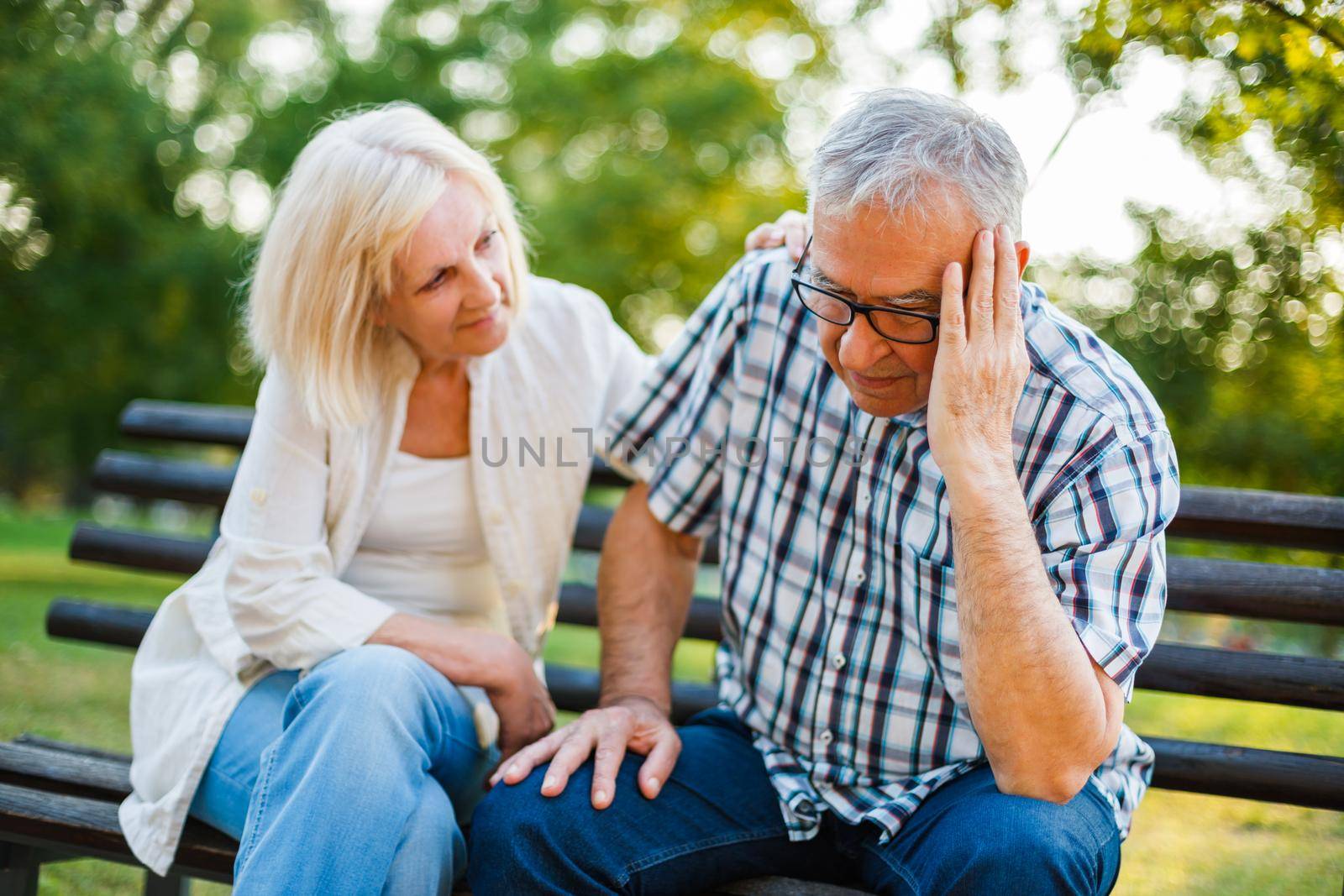 Senior man is sad and depressed. Friend is consoling him.