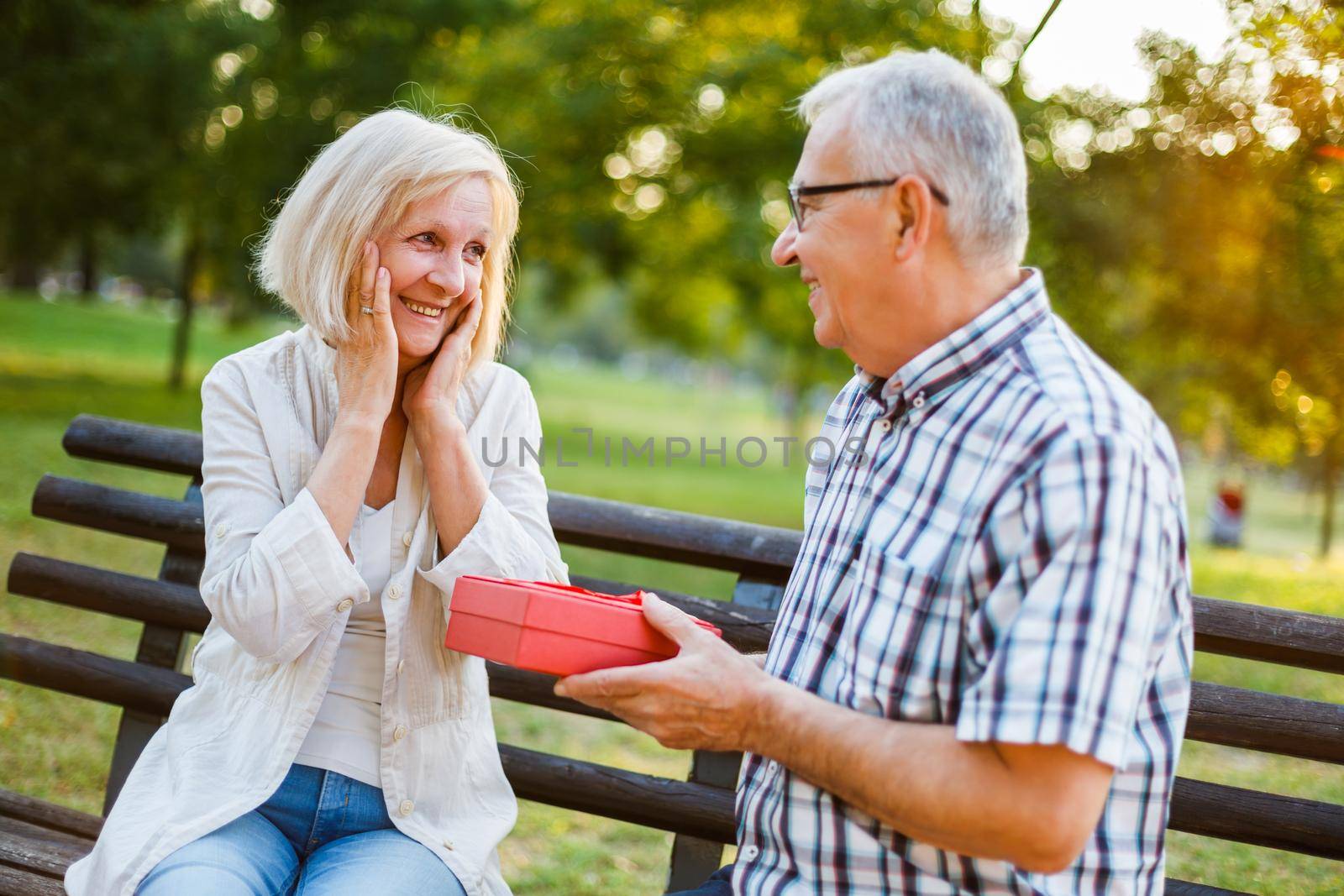 Senior woman is delighted with gift from her man.