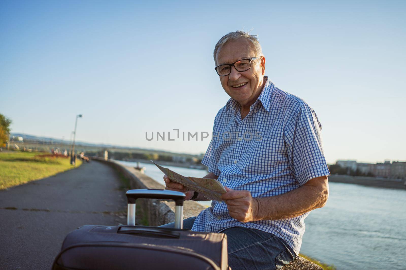 Outdoor portrait of senior man who is on city tour.
