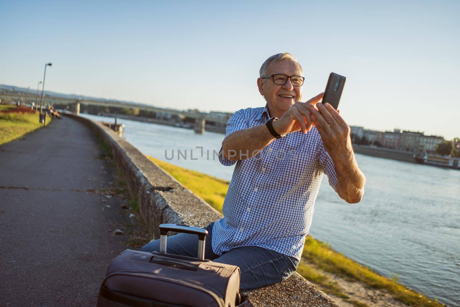 Outdoor portrait of senior man who is traveling.