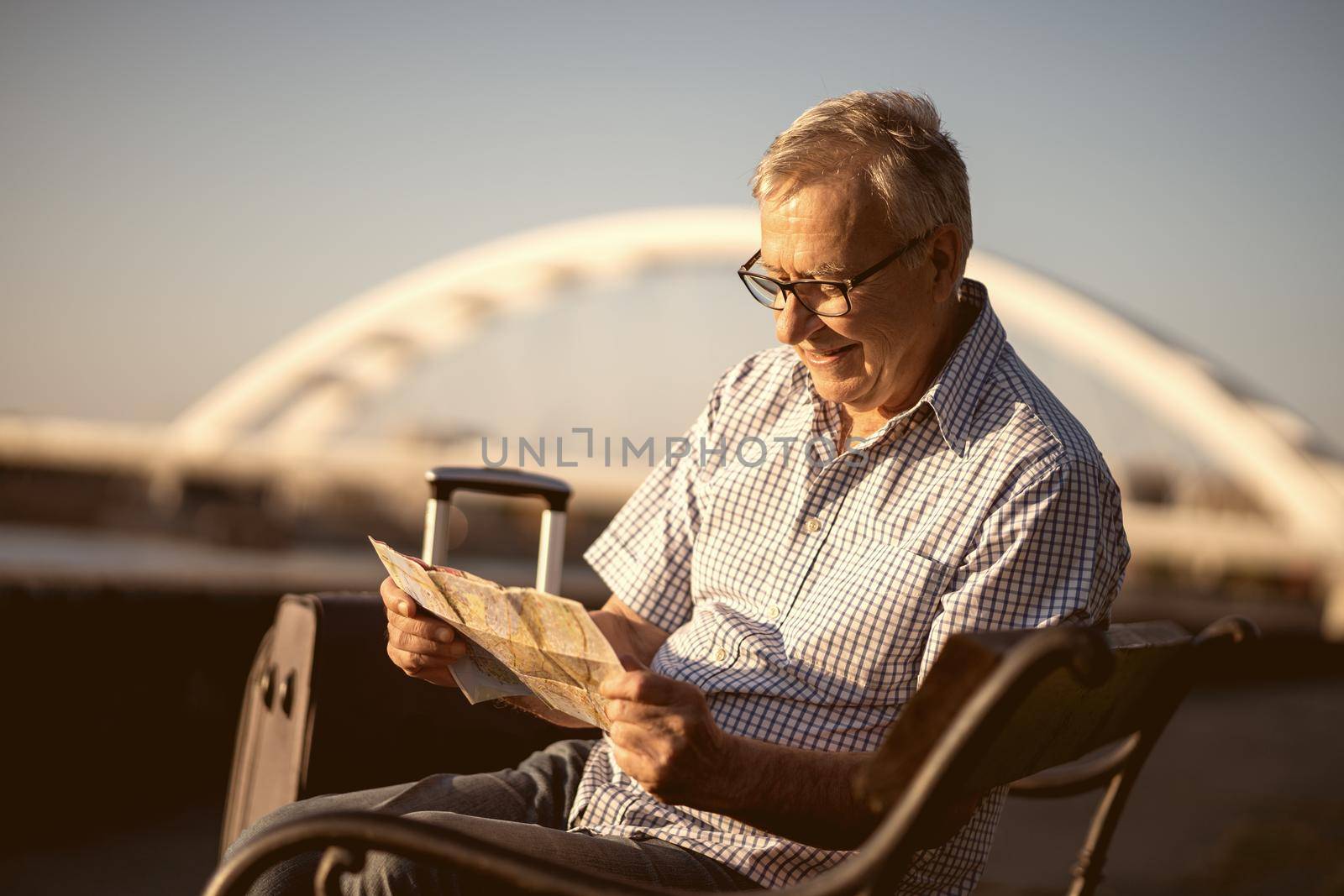 Outdoor portrait of senior man who is on city tour.
