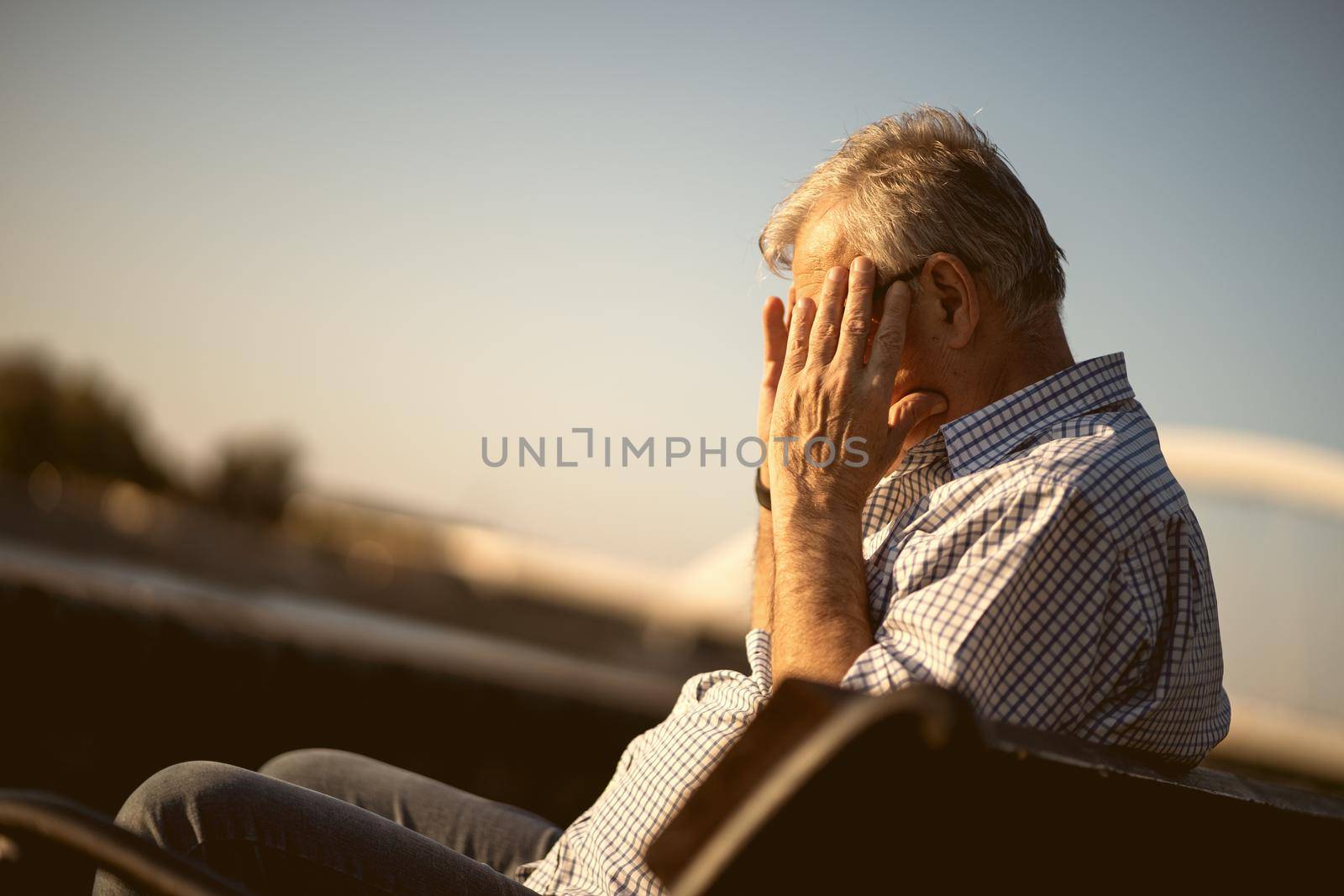 Outdoor portrait of worried and depressed senior man.