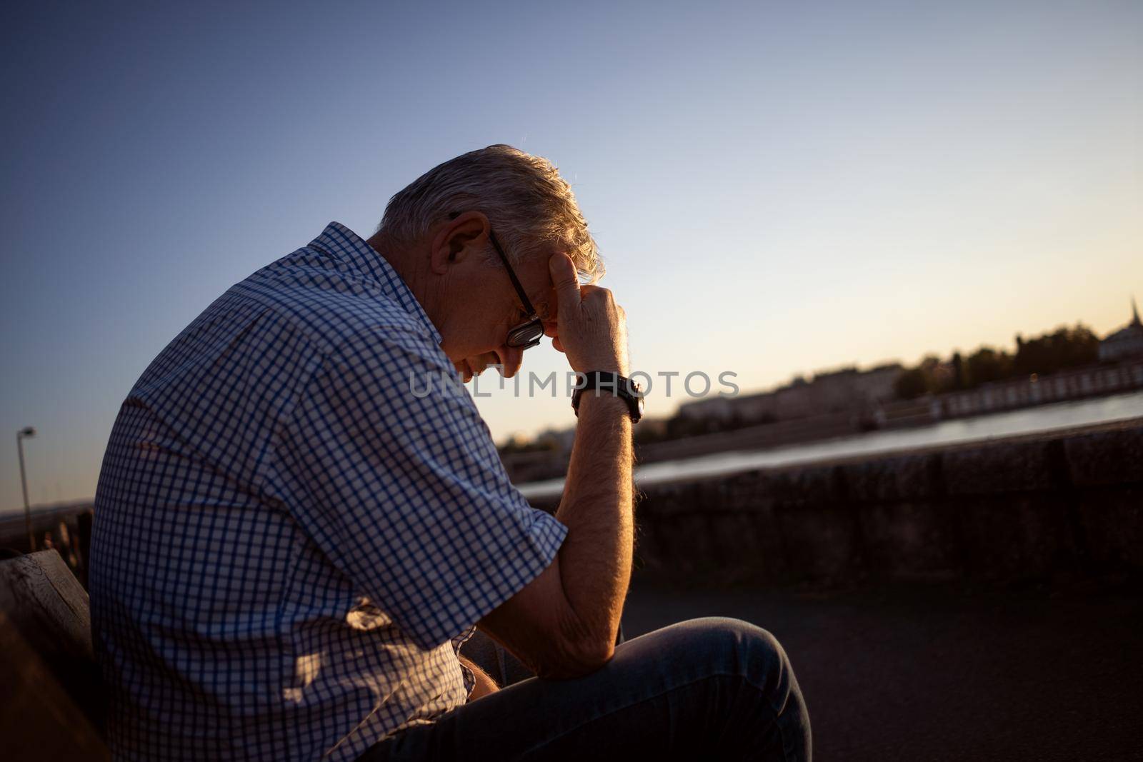 Outdoor portrait of worried and depressed senior man.