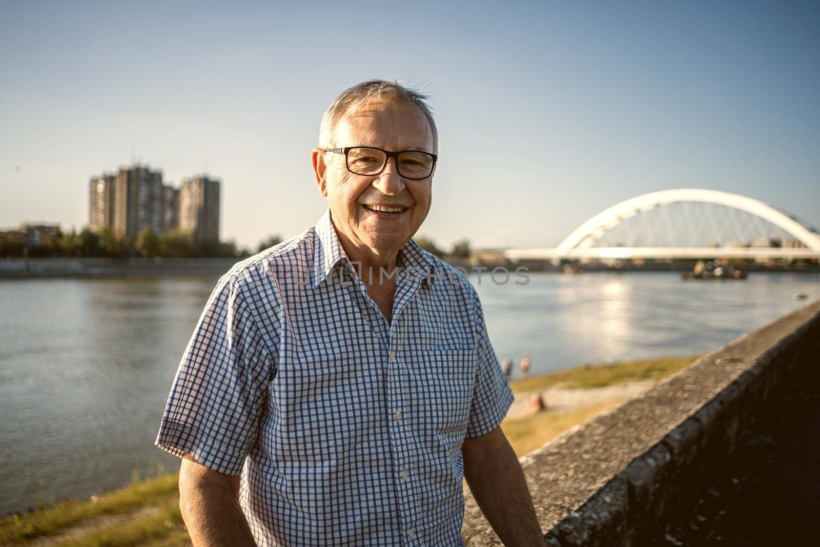 Outdoor portrait of happy senior man who is smiling.