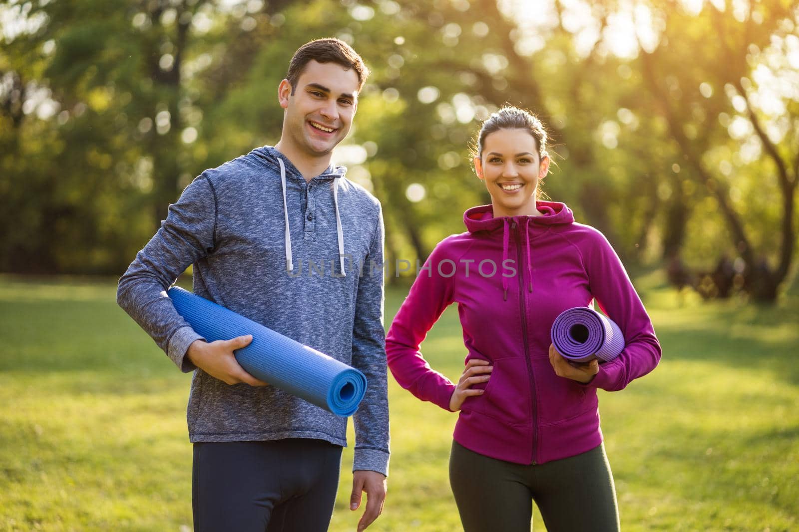 Young couple is ready for exercising in park.
