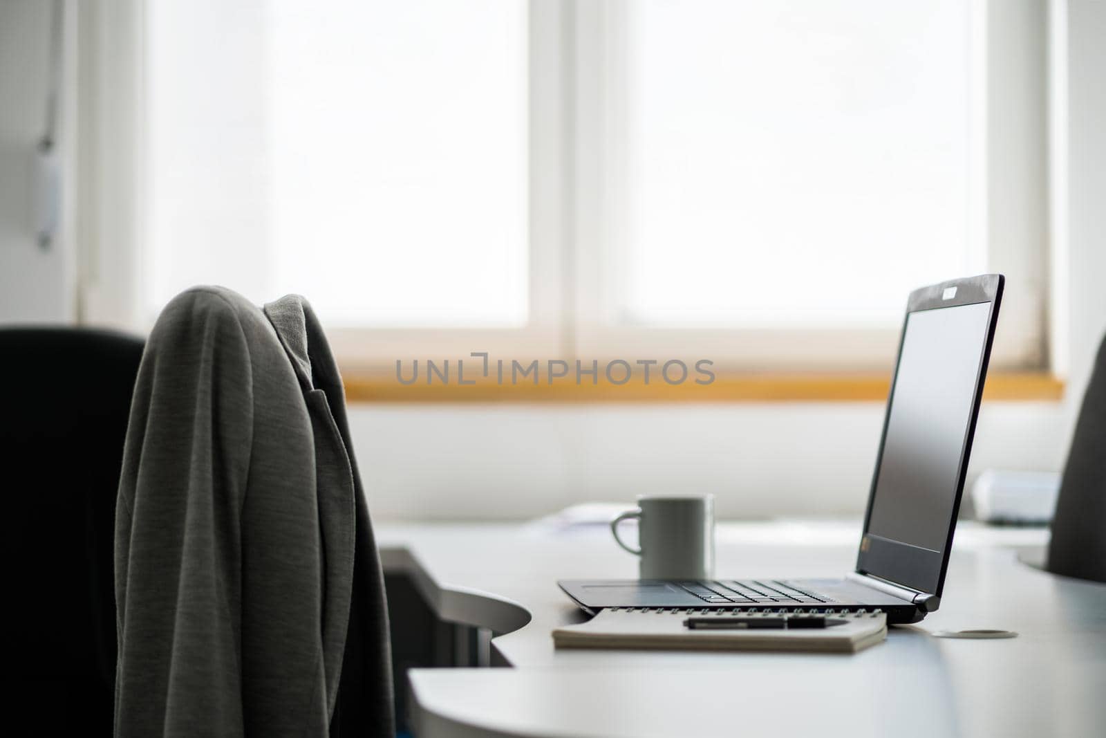 Image of desk with laptop in business office.