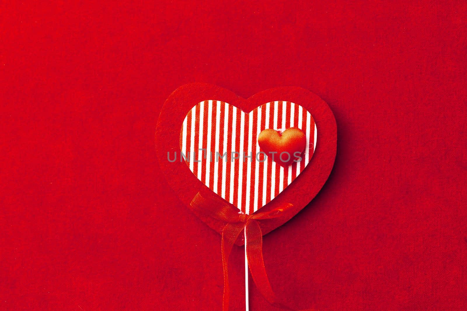 red striped heart shape decoration on textile background by nikkytok