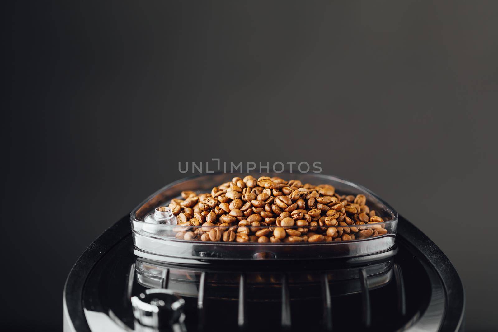 coffee beans in coffeemaker bean container, copy-space background