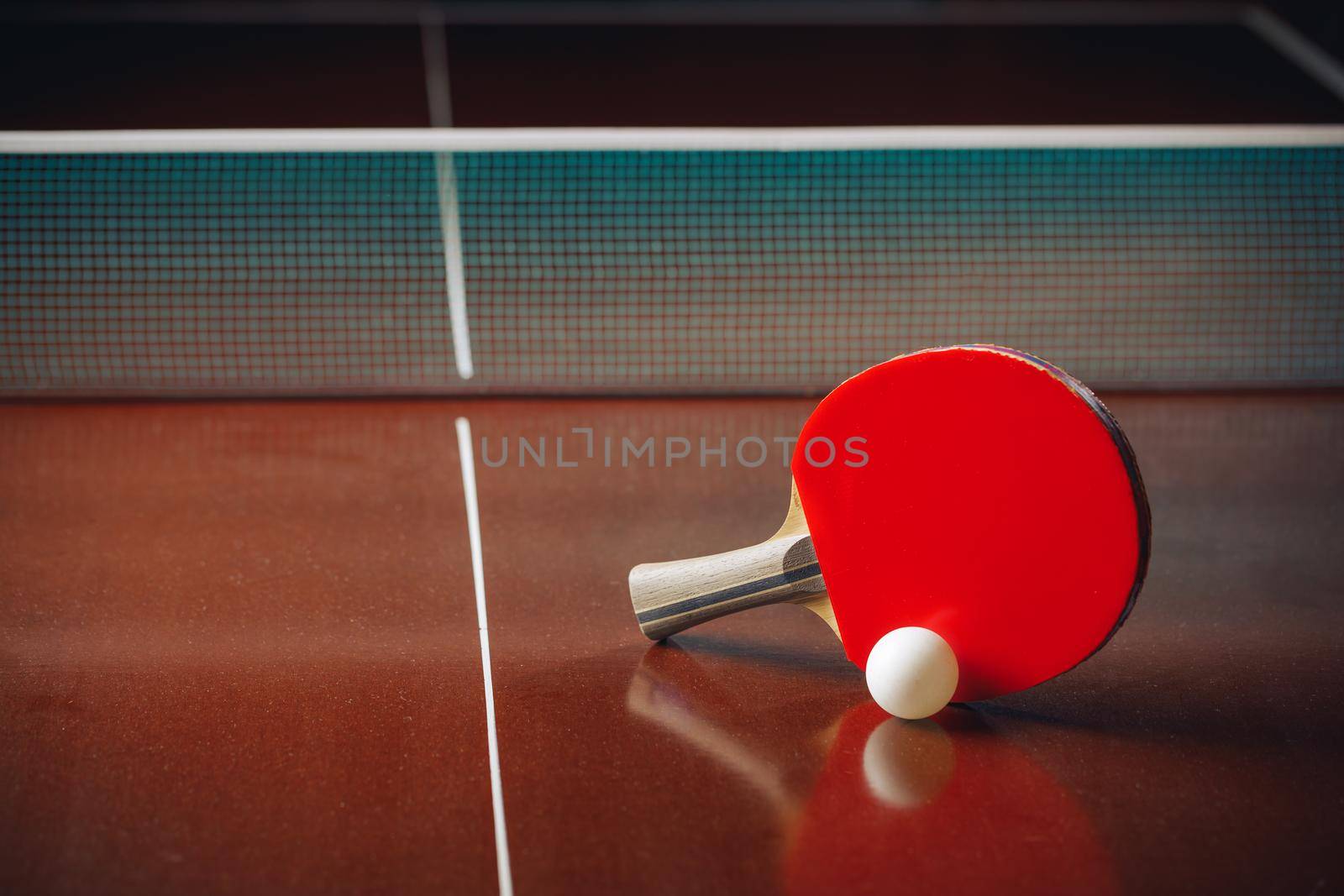 table tennis racket and ball, net background