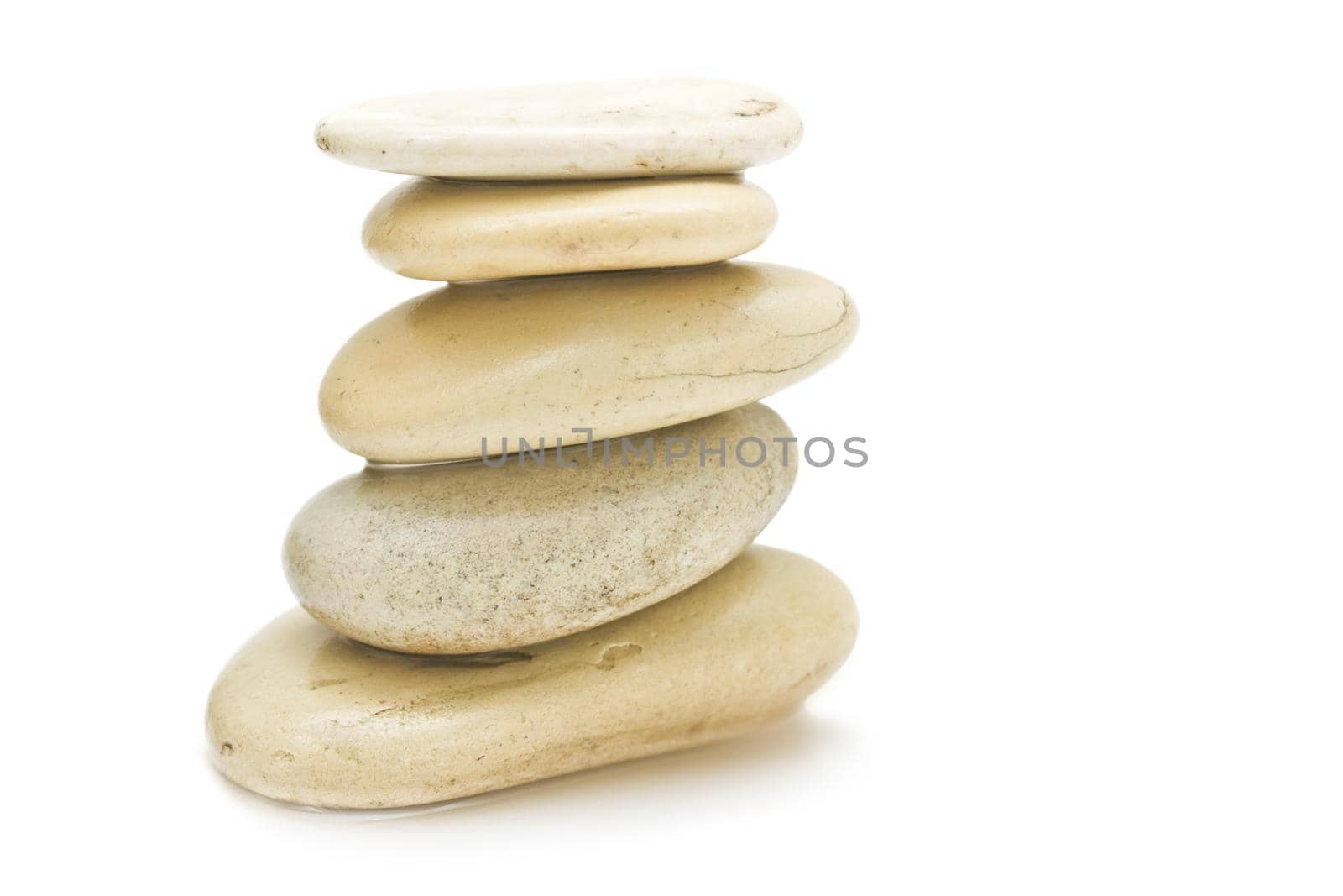 pile of hot massage stones - beauty, spa and body care styled concept by Anneleven