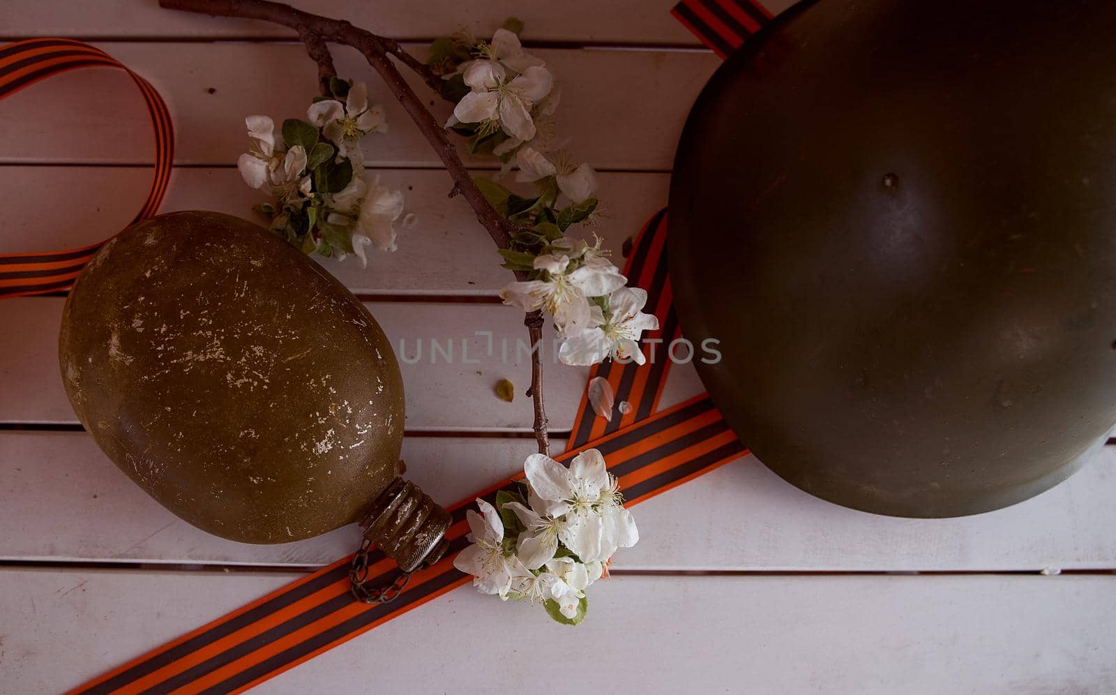 Soldier's flask with St. George ribbons. Victory Day Photos. High quality photo