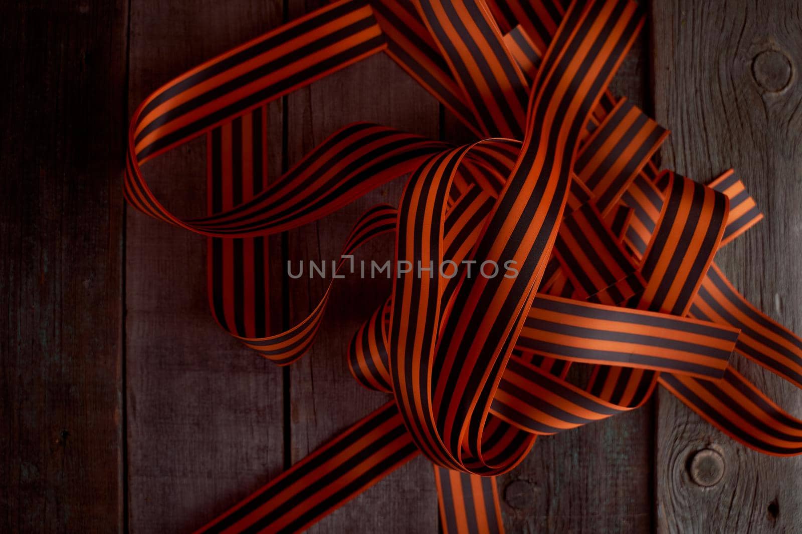 Black orange St. George ribbons on a wooden background. High quality photo