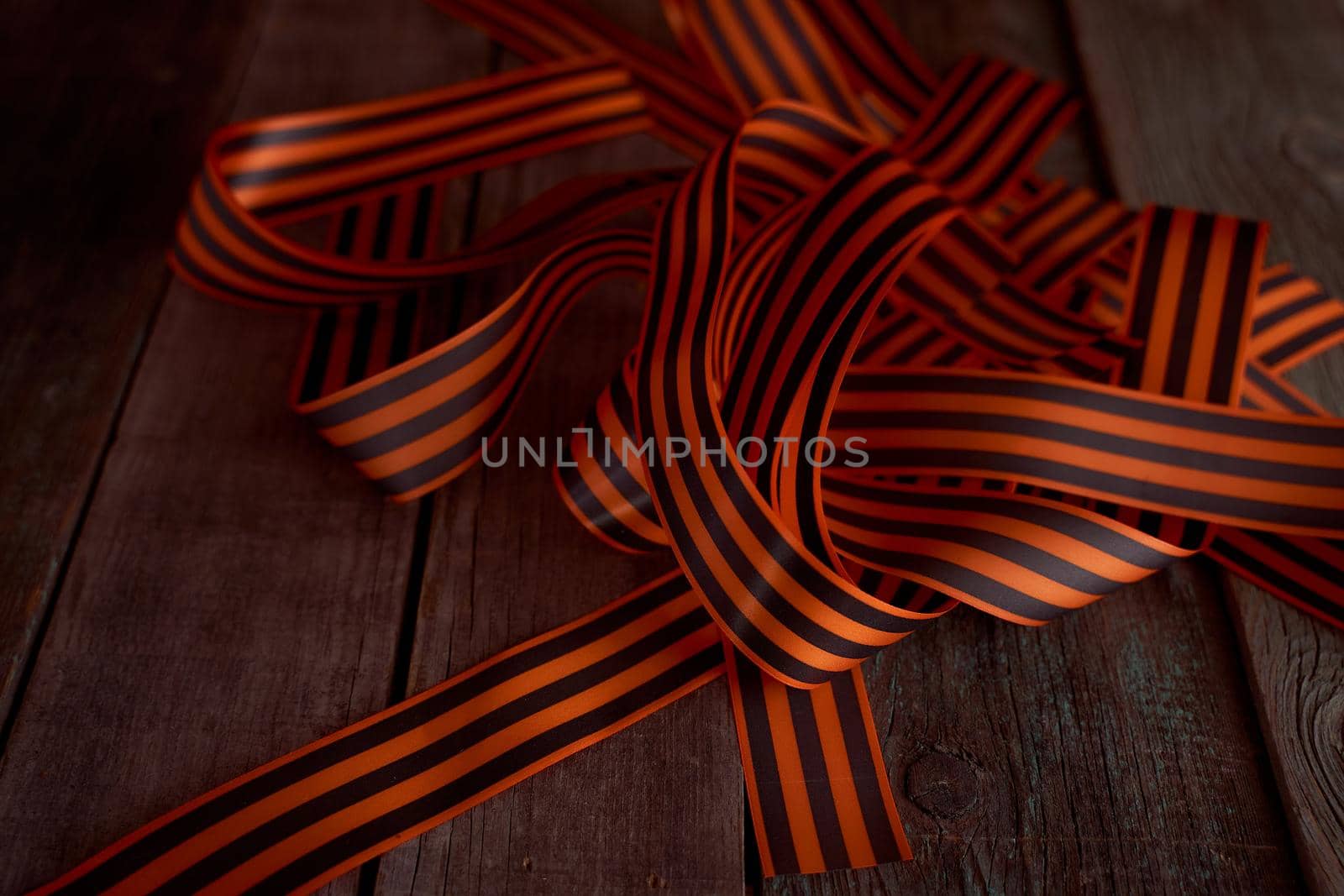 Black orange St. George ribbons on a wooden background. High quality photo