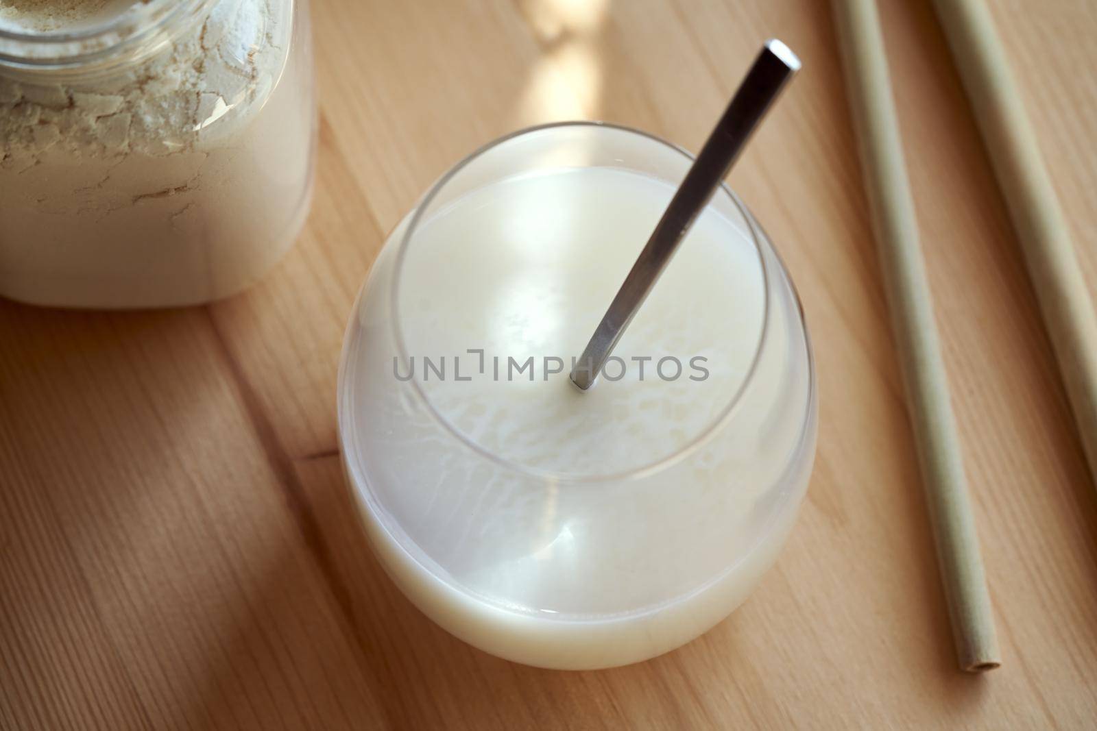 Whey protein powder mixed with water - a healthy protein drink, with bamboo straws by madeleine_steinbach