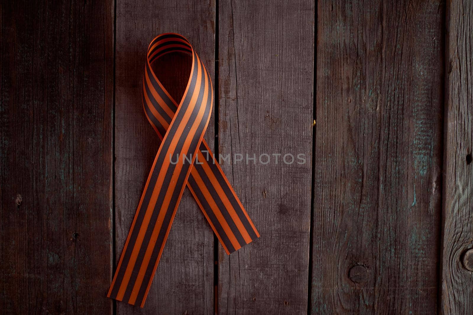 Folded St. George ribbon on a wooden background by Xelar
