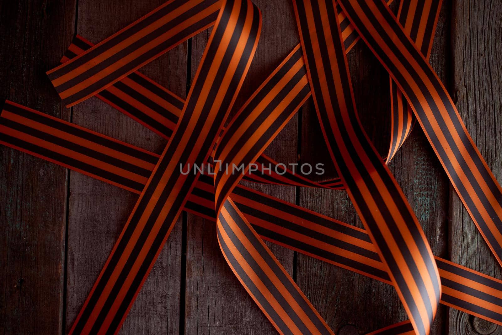 Black orange St. George ribbons on a wooden background. High quality photo