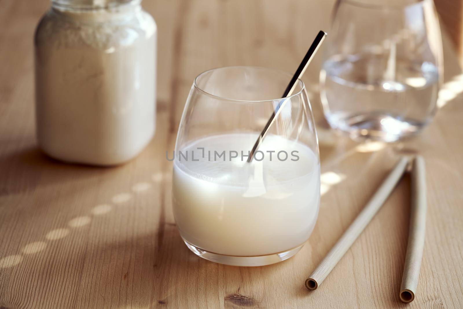 Healthy drink made of whey protein powder and water, with bamboo straws