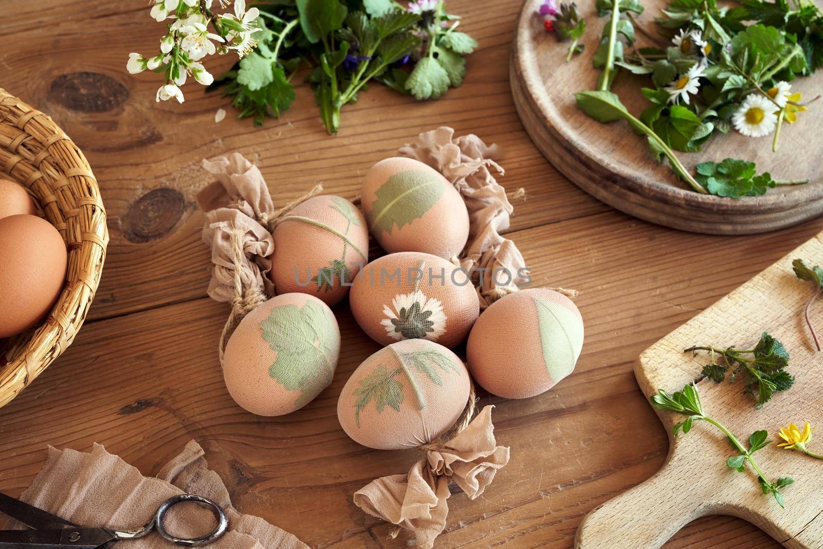 Easter eggs with fresh leaves attached to them - preparation for dyeing Easter eggs with onion peels by madeleine_steinbach