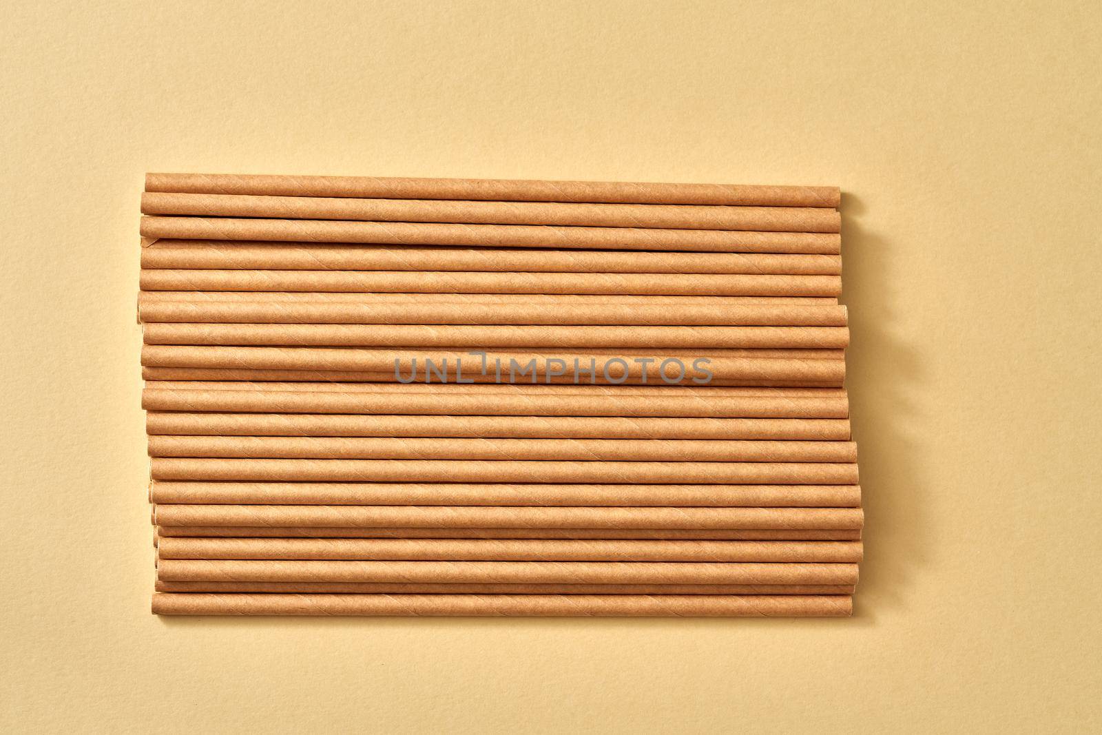 Paper straws on a beige background - zero-waste or ecology concept