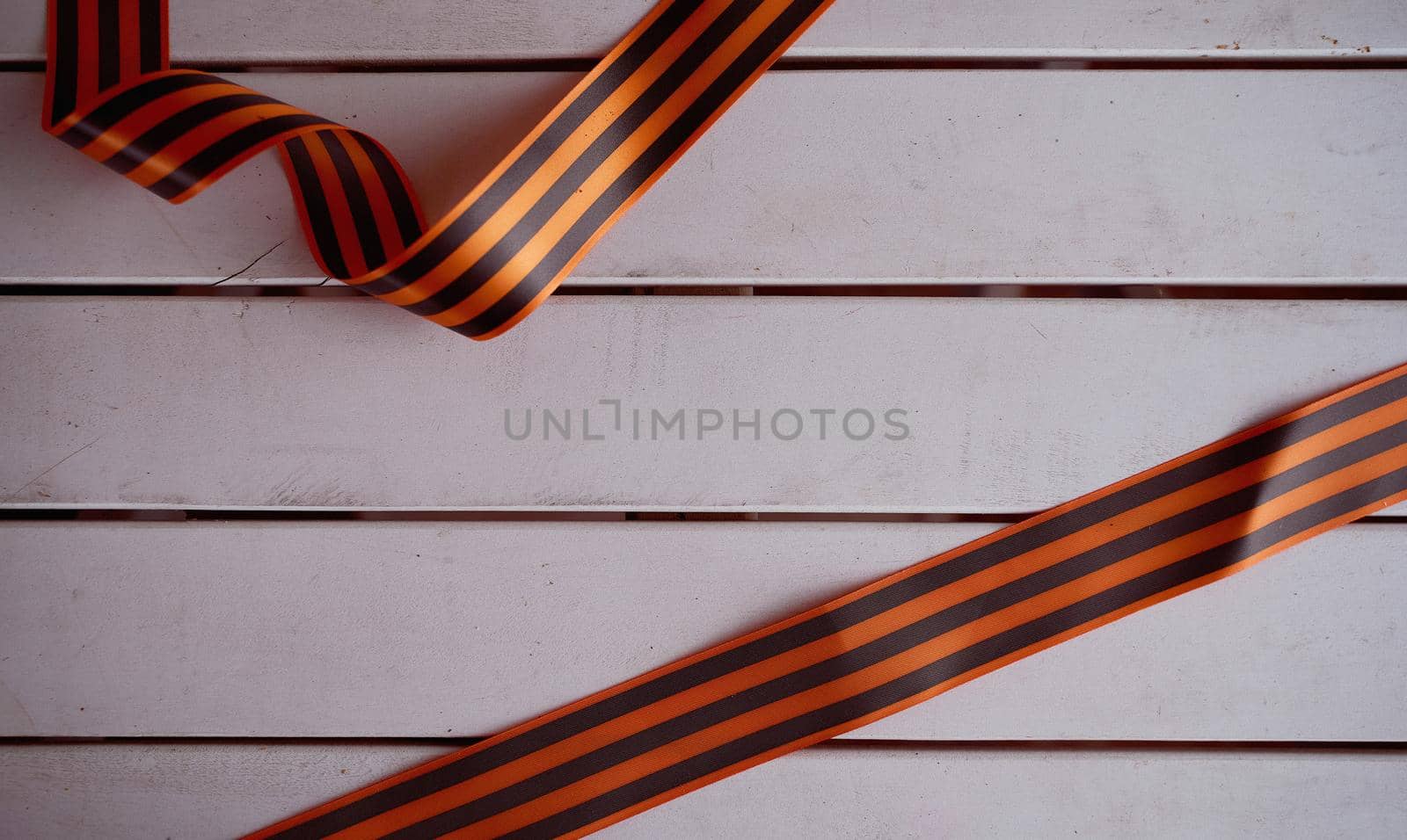 Folded St. George ribbon on a wooden background. High quality photo