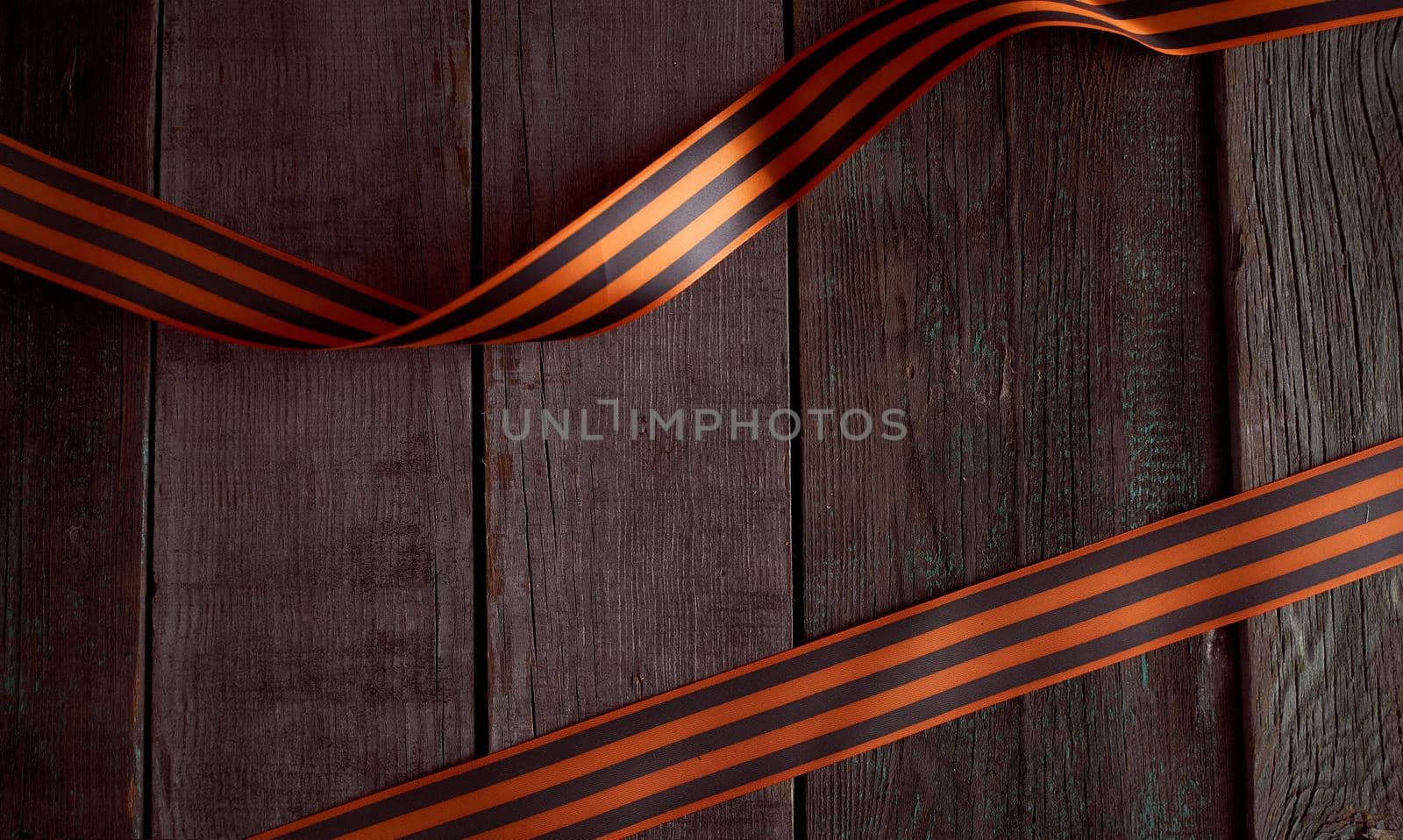 Folded St. George ribbon on a wooden background. High quality photo