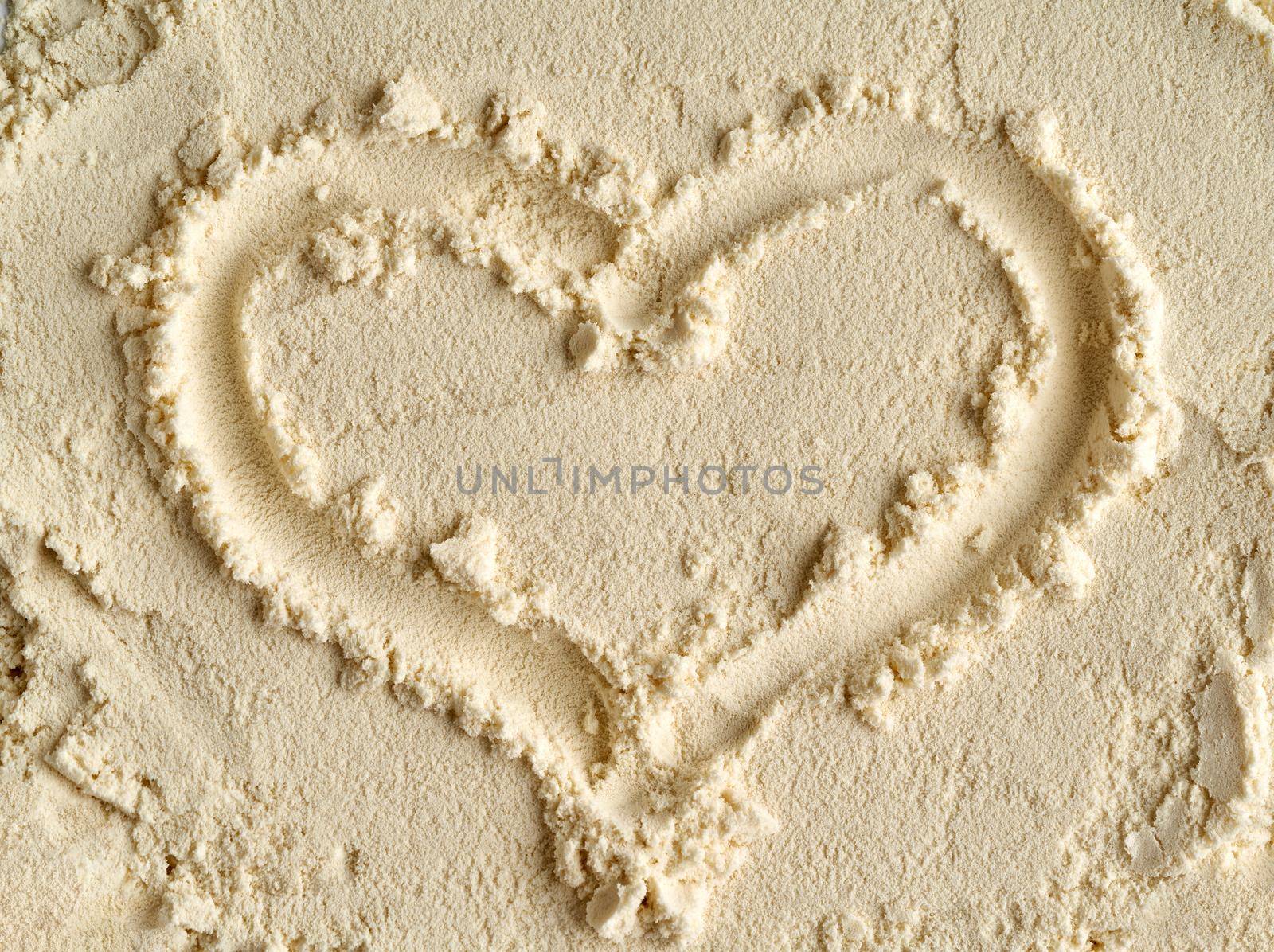 Heart shape made of whey protein powder, top view