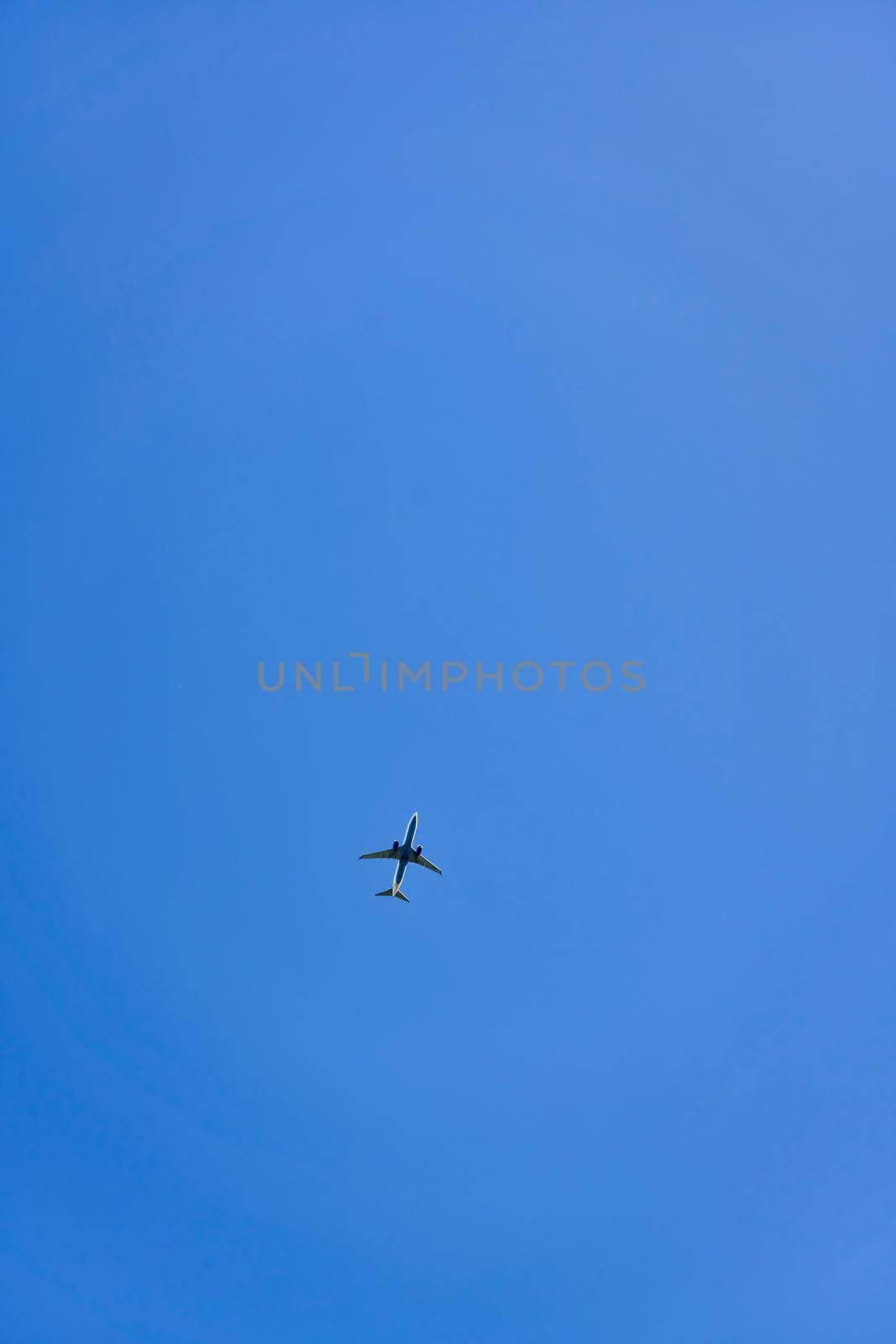 High flying passenger plane against the blue sky by vizland