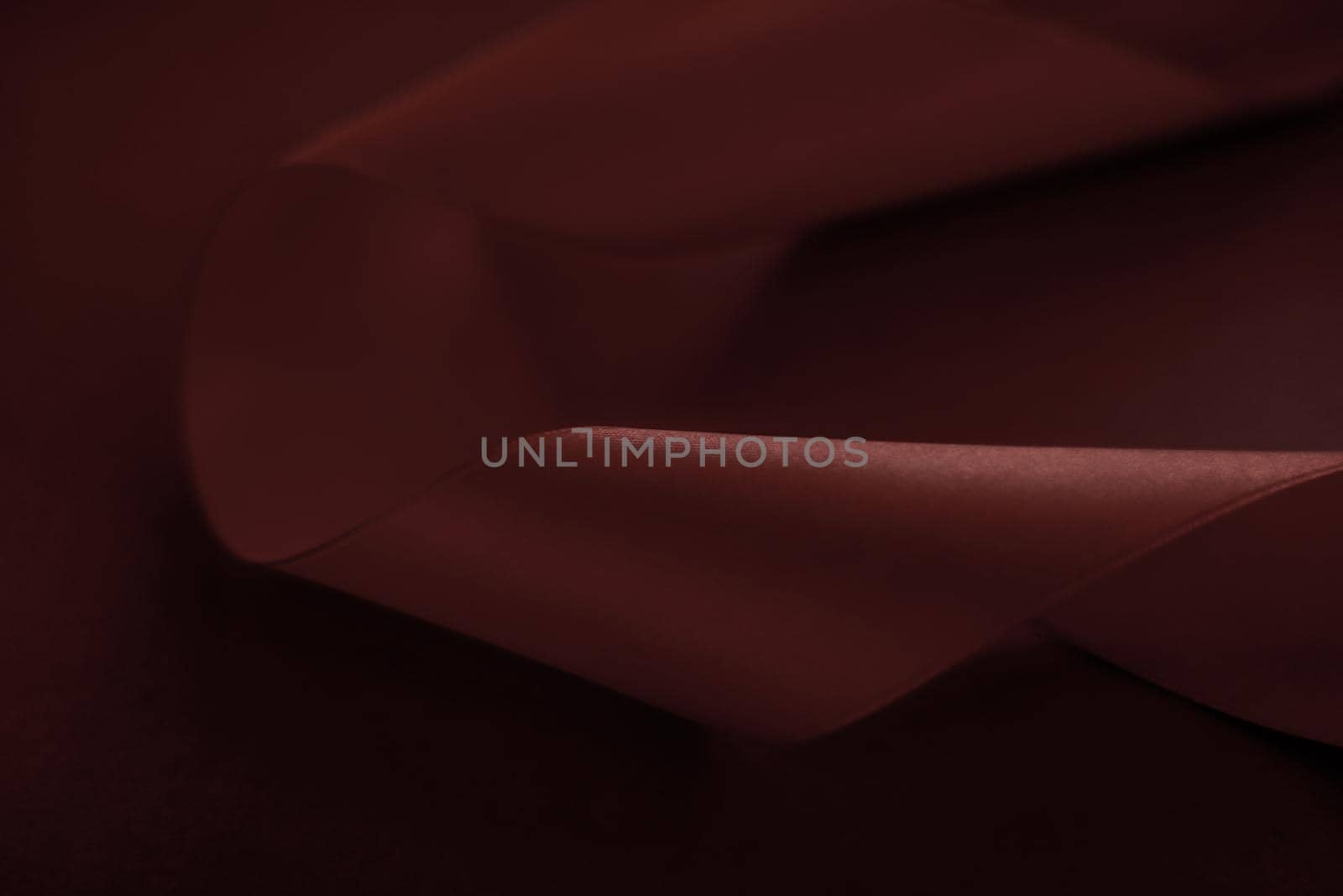 Branding, holidays and luxe brands concept - Abstract silk ribbon on chocolate background, exclusive luxury brand design for holiday sale product promotion and glamour art invitation card backdrop