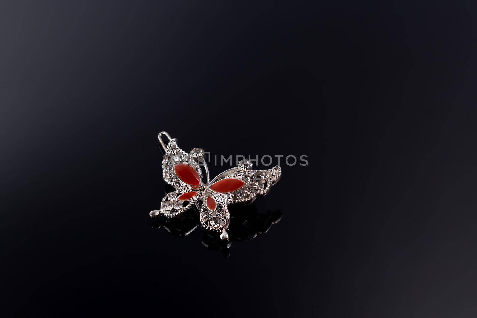 Bijouterie and jewelry on a dark background. Brooches and hairpins earrings and pendants. Copy space