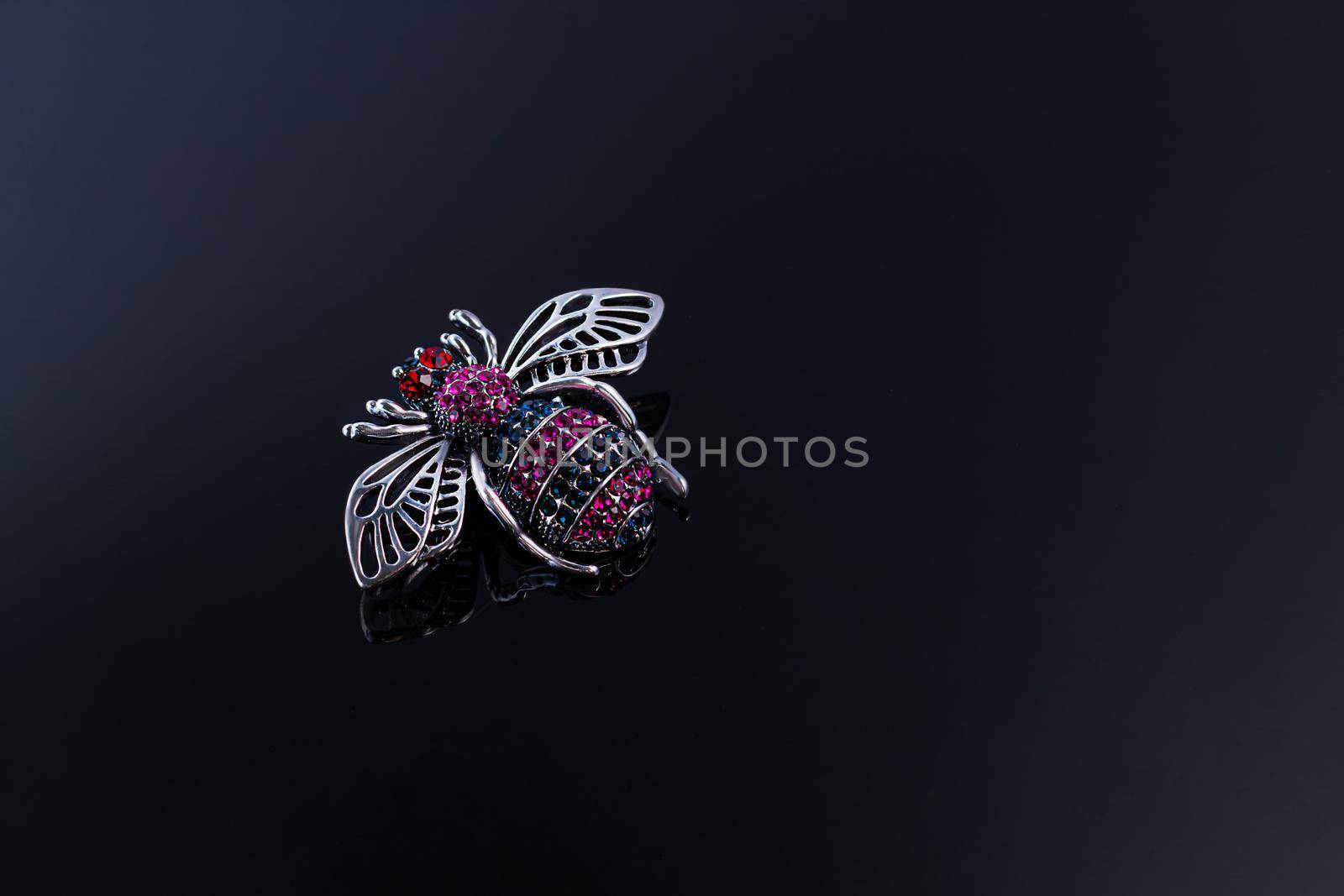 Bijouterie and jewelry on a dark background. Brooches and hairpins earrings and pendants. Copy space