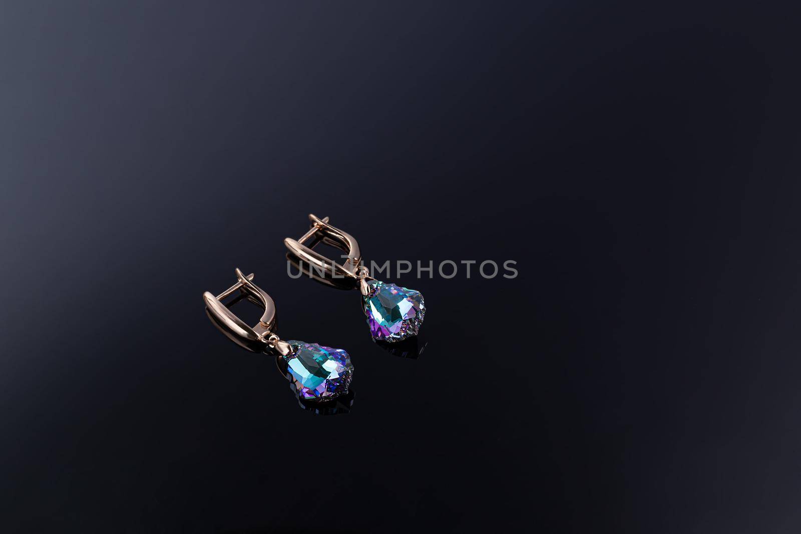 Bijouterie and jewelry on a dark background. Brooches and hairpins earrings and pendants. Copy space