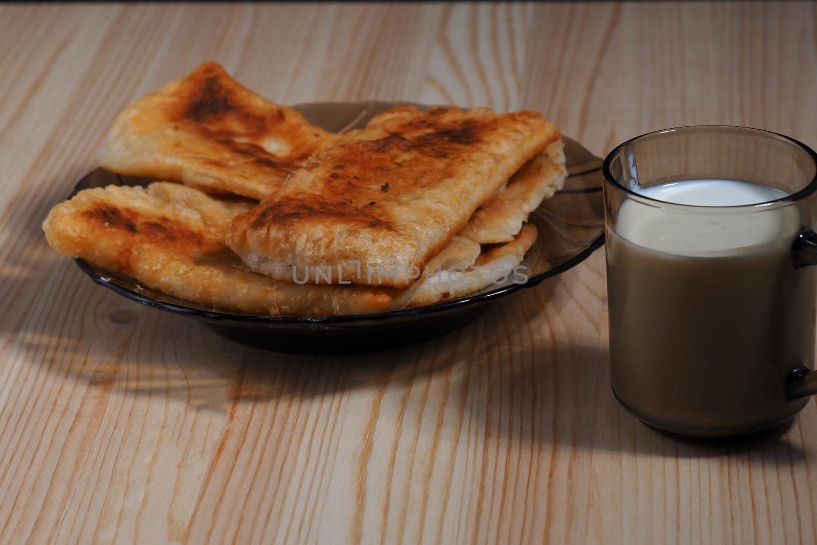 Homemade food. Pies and a glass of milk on the table. by Olga26